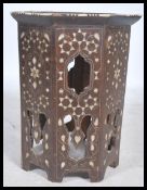 An Eastern 19th century octagonal Benares table profusely inlaid with silver, mother of pearl and