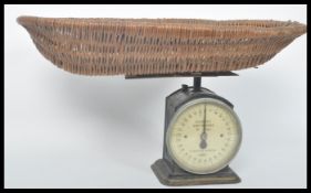 A vintage early 20th century Hughes's baby weight weighing scales by Salter. Raised on a square base