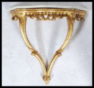 A vintage 20th century small marble topped gilt scroll work wall mounted console table. Measures: