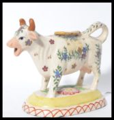 A 19th century Victorian Staffordshire pottery milk creamer jug in the form of a cow with painted