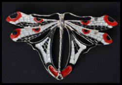 A sterling silver and enamel butterfly bug brooch having white red and black enamel with pin to