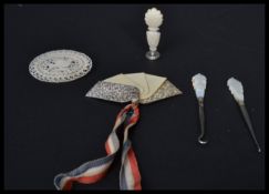 A group of hallmarked silver and mother of pearl items to include picks, brooch etc. Please see