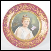 A 19th century hand painted cabinet plate having a red border with gilt decoration. The plate