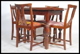 A 1930's Art Deco oak draw leaf refectory dining table and 4 chairs. The table with block and turned