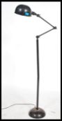 A retro mid century Industrial factory standard lamp raised on terraced base having tall