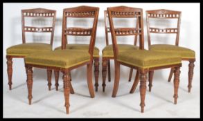 A set of six early 20th century Edwardian oak dining chairs, overstuffed seats, gallery spindle back