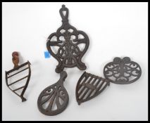 A collection of five ( 5 ) 19th century Victorian cast iron ornate trivets to include Irons and