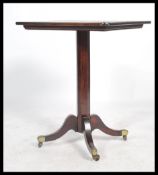 A 19th century mahogany side table being raised on shaped and reeded legs with brass cap castors