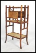 A 19th century Victorian aesthetic movement bamboo Canterbury magazine stand having a wicker panel