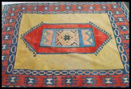 A large 20th century Persian woollen rug having a central medallion with beige ground having