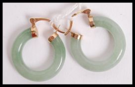 A pair of hallmarked Jade and 9ct gold hoop earrings, the gold mounts marked with makers marks for