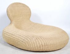 A contemporary whicker oversized chaise longue day bed of pebble form with shaped back rest.