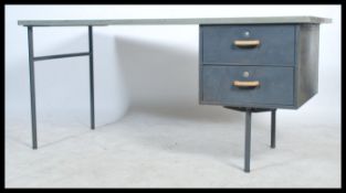 A retro mid 20th century military / industrial single pedestal desk, raised on metal tubular legs