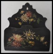 A 19th century Victorian ebonised hand painted folk tolewre letter rack having painted floral