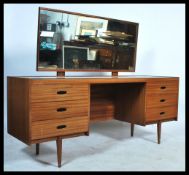 A retro 20th century teak wood dressing table having reeded drawer fronts with central kneehole