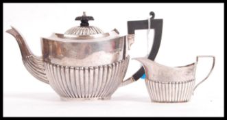 A part silver hallmarked tea service to include teapot and creamer, Birmingham assay marks, makers