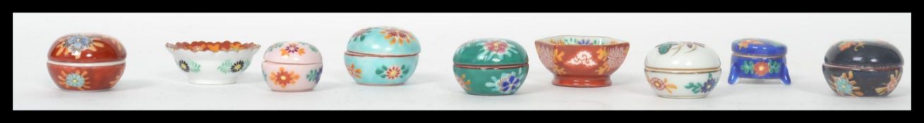 A collection of 20th century Japanese small miniature Imari lidded dishes and bowls, some with