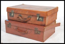 A good early 20th century leather suitcase with remains of original shipping labels together with