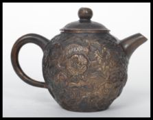 A 19th century Chinese bronze Yi Xing teapot of globular form. The body having Fu Dog decoration