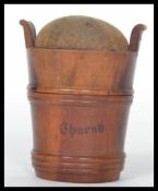 A 19th century treen pin cushion in the form of a bucket with twist off lid and baize cushion
