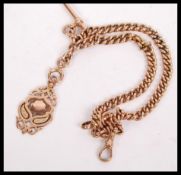 A 9ct gold pocket watch albert chain having an armorial scrolled fob. The fob hallmarked for