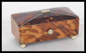 A 19th century Georgian tortoiseshell counter box of sarcophagus form. The sloped lid having