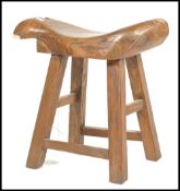 A Chinese elm wood fish stool. Raised on squared l