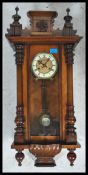 A 19th century Victorian walnut vienna regulator wall clock in the manner of Gustav Becker having an