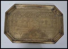 A 19th century Indian / Islamic brass tray of elongated hexagonal form profusely engraved with