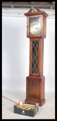 A 20th century antique style oak longcase grandfather clock with brass face and roman numeral