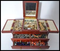 A collection of vintage costume dress jewellery to include rings necklaces bangles etc. contained