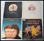 Queen Vinyl Records - A group of four Long play LP vinyl records by Queen to include A Night At