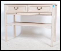 A 20th century contemporary limed oak console table - writing table desk being raised on squared