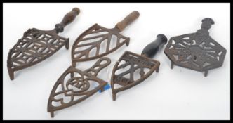 A collection of five ( 5 ) 19th century Victorian cast iron ornate trivets to include Irons and