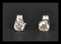 A pair of white gold and diamond stud earrings of approx 83 points. Complete in presentation box.