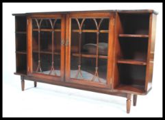 A mid 20th century mahogany glazed bookcase, a pair of central astral glazed doors flanked by open