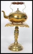 A 19th century brass pedestal trivet and kettle. The pierced top trivet on turned column support,