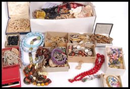 A large box of vintage costume jewellery including silver, old pearl necklaces one with clasp marked