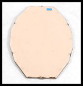 A vintage 20th century Art Deco peach glass bevelled mirror of do-decagon form having 12 faceted