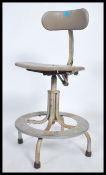 A retro 20th century medical / Industrial swivel office chair having chrome tubular frame with