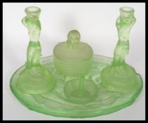 An Art Deco Lalique inspired green pressed glass Dressing Table Set consisting of tray, two