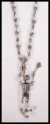 A sterling silver watch chain having multiple scull shaped links. Weighs 46 grams.
