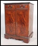 A 20th century Georgian style flame mahogany hi-fi / entertainment cabinet having a hinged top and