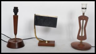 A group of three mid 20th century teak table desk lamps to include a library example and two