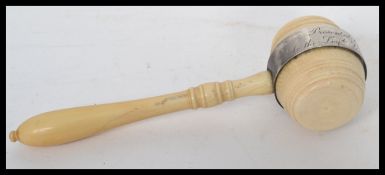 A 19th century Masonic interest ivory gavel having silver plated mounts. The handle of turned