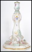A 19th century Meissen ceramic table lamp of scrolled form hand painted with floral sprays and