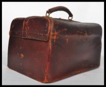 A 19th century Victorian leather doctors Gladstone type case, the double opening top with brass