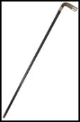 A 19th century silver hallmarked walking stick cane having a tapering ebonised shaft with shaped