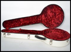 A good quality contemporary Calton white banjo case with red velvet lined sectional interior. Makers