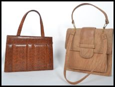 Two vintage mid 20th century ladies handbags to include a pale leather bag with detachable